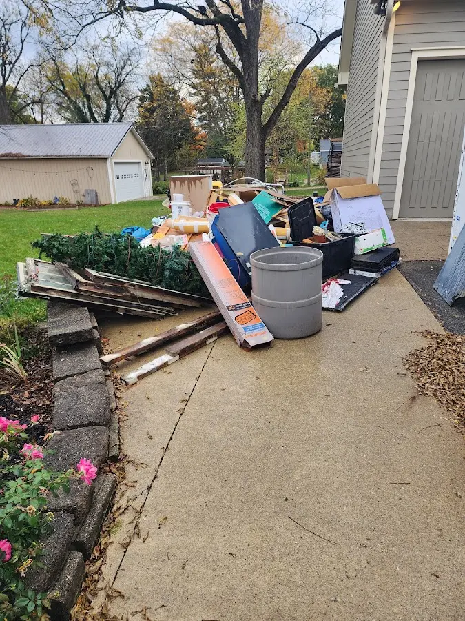 Dumpster being loaded with debris for 10 Yard Dumpster Rental in Normandy Park